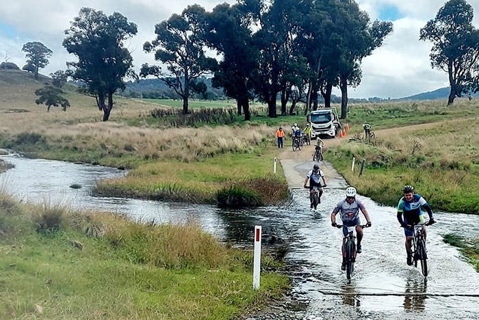 Tour-De-Rocks-riders-navigating-flooded-creek