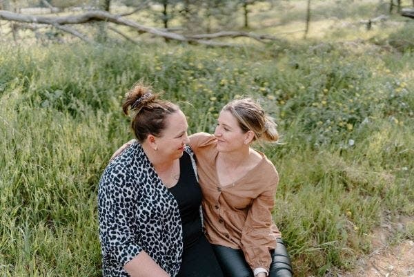 Two Women Hugging and Smiling