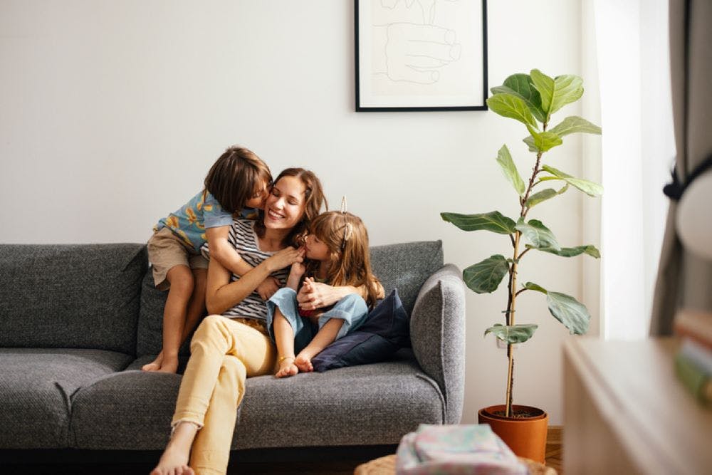 mum with her two daughters in the sofa
