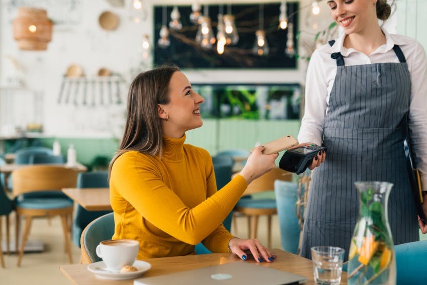 Woman smiling paying with her digital card