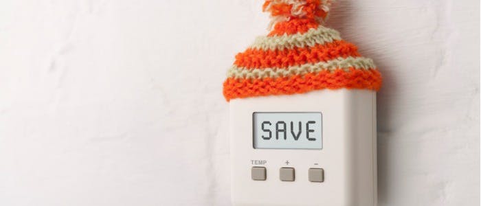 on-digital-room-thermostat-with-wooly-hat-picture-id175255091